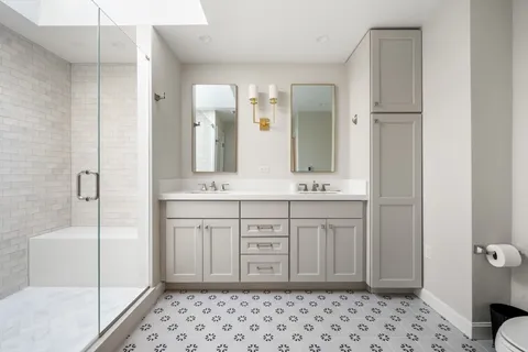 a bathroom with a sink a toilet and shower