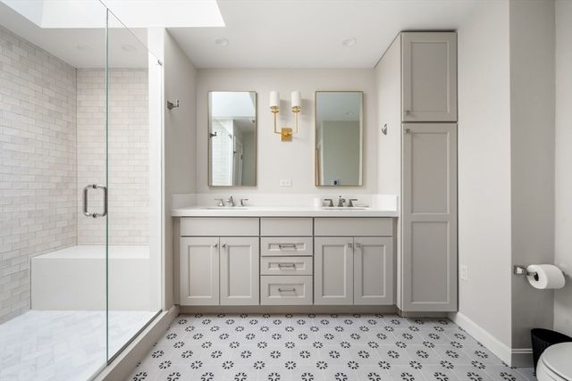 a bathroom with a sink a toilet and shower