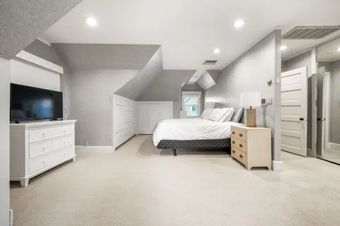 a bedroom with furniture and a flat screen tv