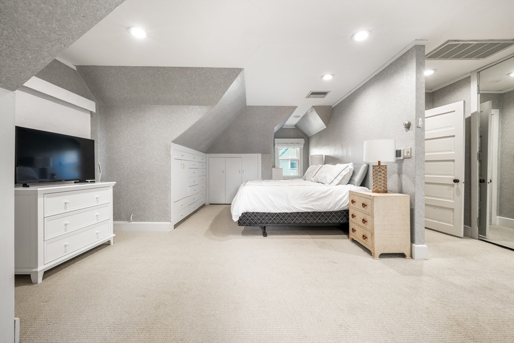 85 Williston Road Brookline, MA 02445 - Photo 19 of 29 a bedroom with furniture and a flat screen tv