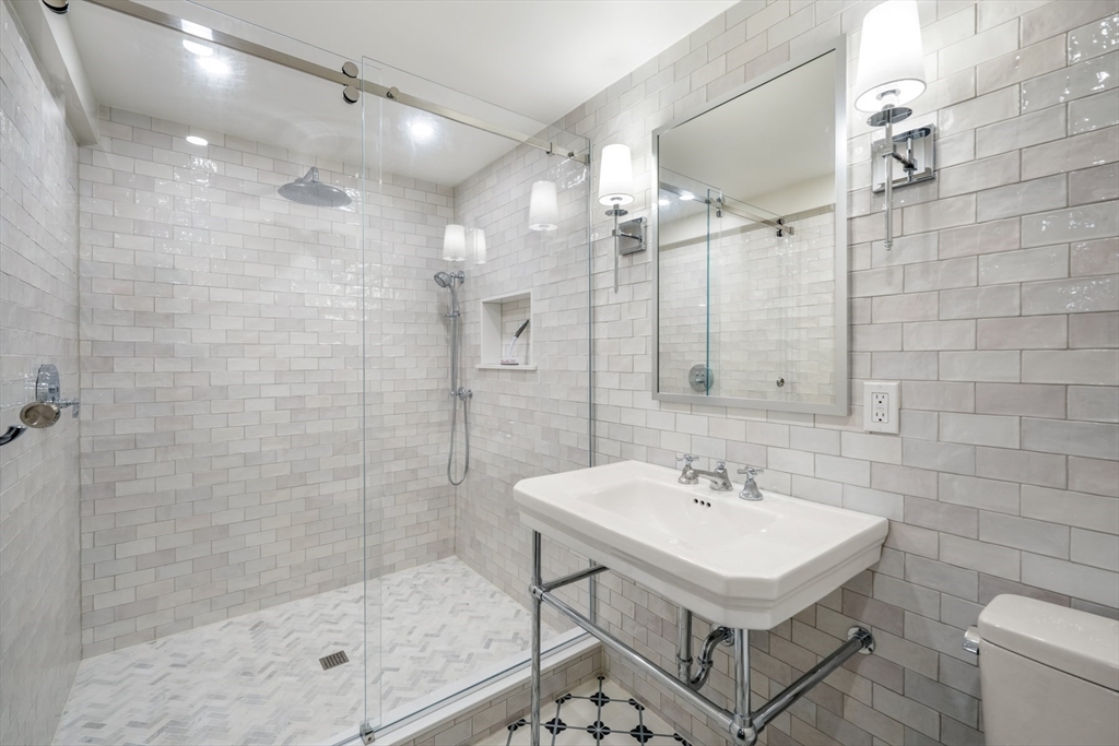 85 Williston Road Brookline, MA 02445 - Photo 20 of 29 a bathroom with a sink shower and a mirror