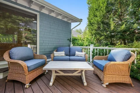a roof deck with a couch and chairs