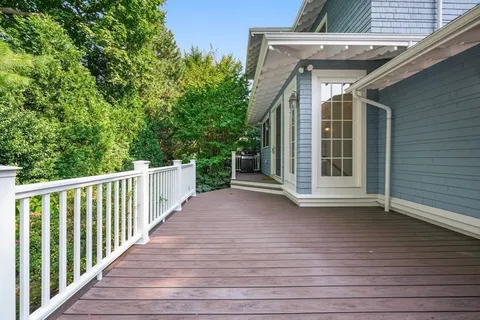 a view of a deck with wooden floor and fence