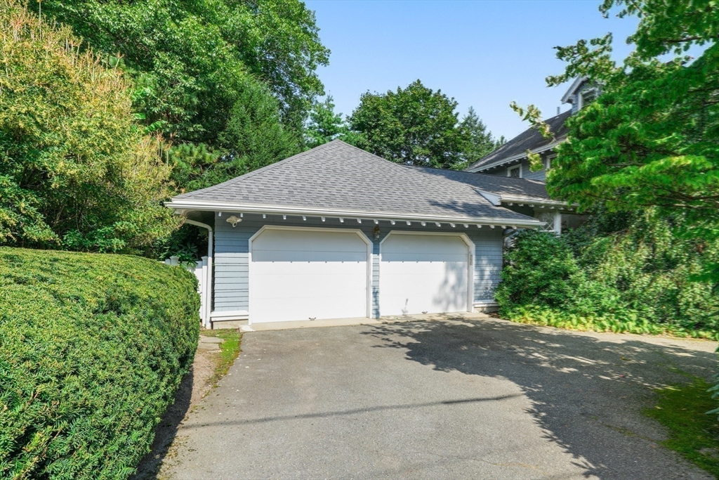 85 Williston Road Brookline, MA 02445 - Photo 25 of 29 a front view of a house with a yard and garage