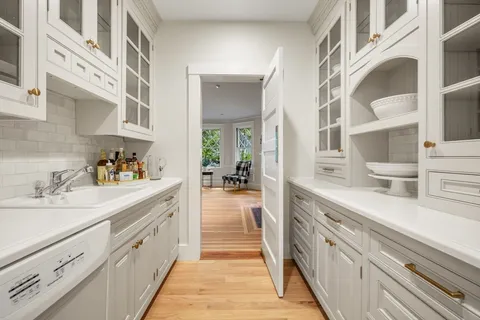 a spacious en suite bathroom with a double vanity sink and mirror
