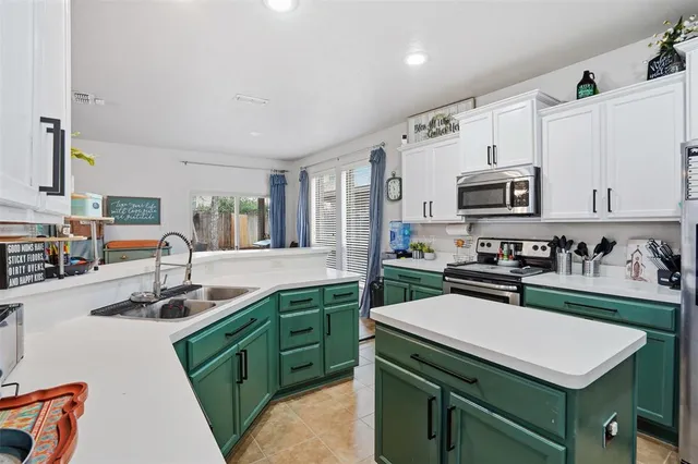 a kitchen with a sink stove top oven and cabinets