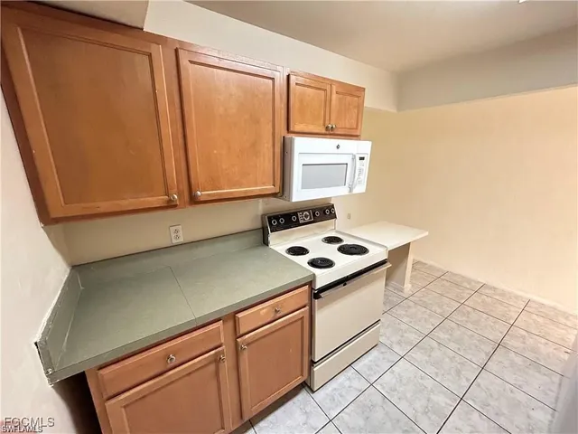 a kitchen with a sink cabinets and appliances