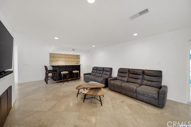 2026 Rimcrest Drive Glendale, CA 91207 - Photo 18 of 44 a living room with furniture and a flat screen tv