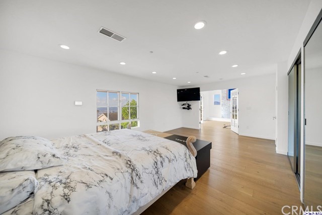 2026 Rimcrest Drive Glendale, CA 91207 - Photo 23 of 44 a spacious bedroom with a bed and a large window