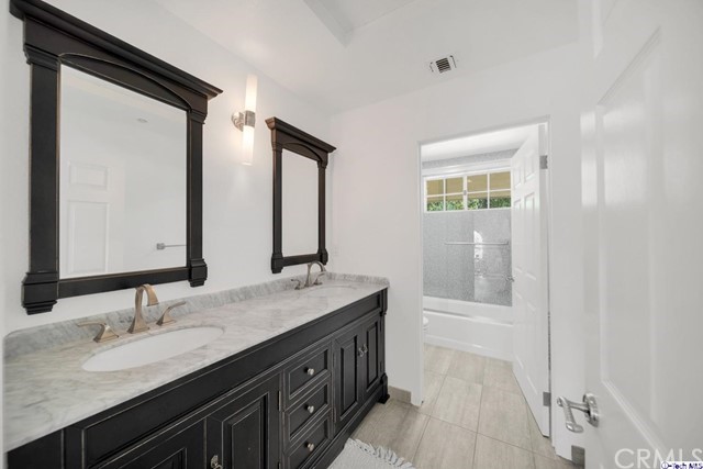 2026 Rimcrest Drive Glendale, CA 91207 - Photo 28 of 44 a bathroom with a double vanity sink and a mirror