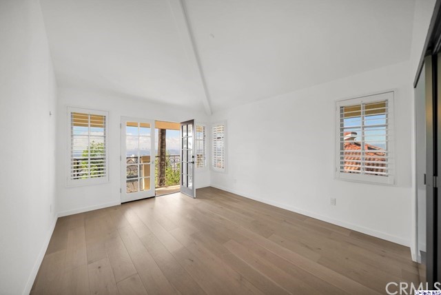 2026 Rimcrest Drive Glendale, CA 91207 - Photo 29 of 44 an empty room with wooden floor and windows