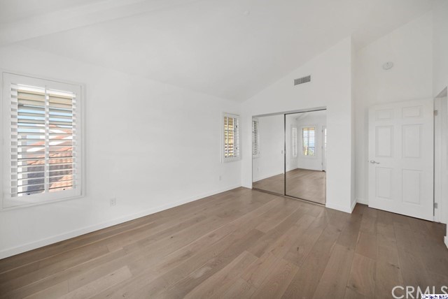 2026 Rimcrest Drive Glendale, CA 91207 - Photo 30 of 44 an empty room with wooden floor and windows