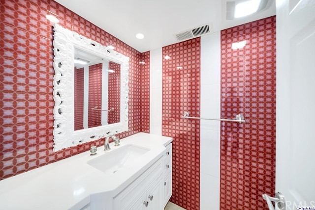 2026 Rimcrest Drive Glendale, CA 91207 - Photo 34 of 44 a bathroom with a granite countertop sink a large mirror and shower