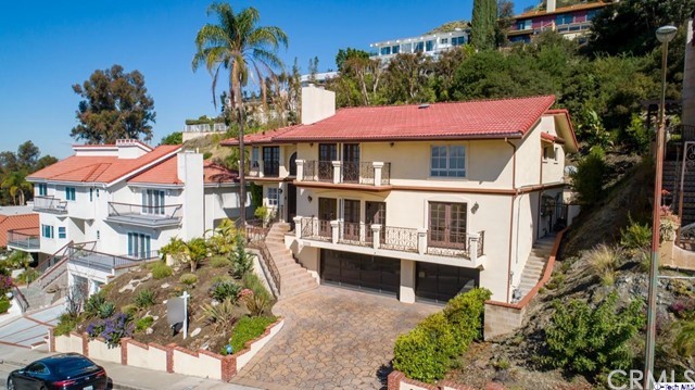 2026 Rimcrest Drive Glendale, CA 91207 - Photo 43 of 44 a view of a house with a yard and potted plants