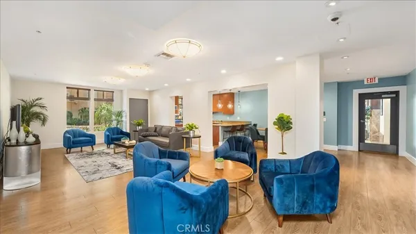 a living room with furniture fireplace and wooden floor