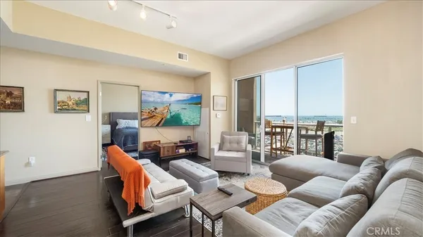a living room with furniture and a floor to ceiling window