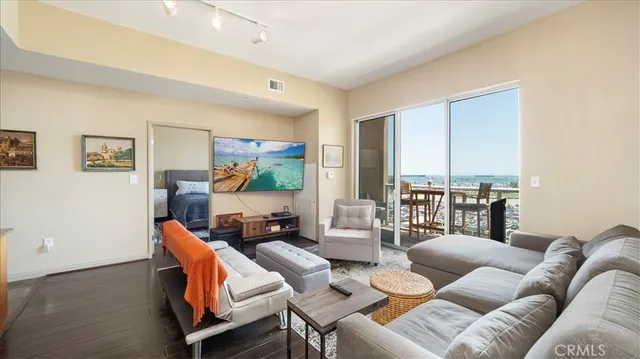 a living room with furniture and a floor to ceiling window