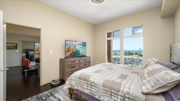 a bedroom with a bed and large windows