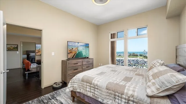 a bedroom with a bed and large windows