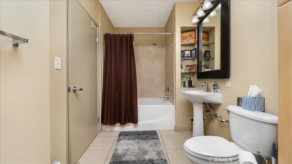 a white toilet sitting next to a bathroom sink