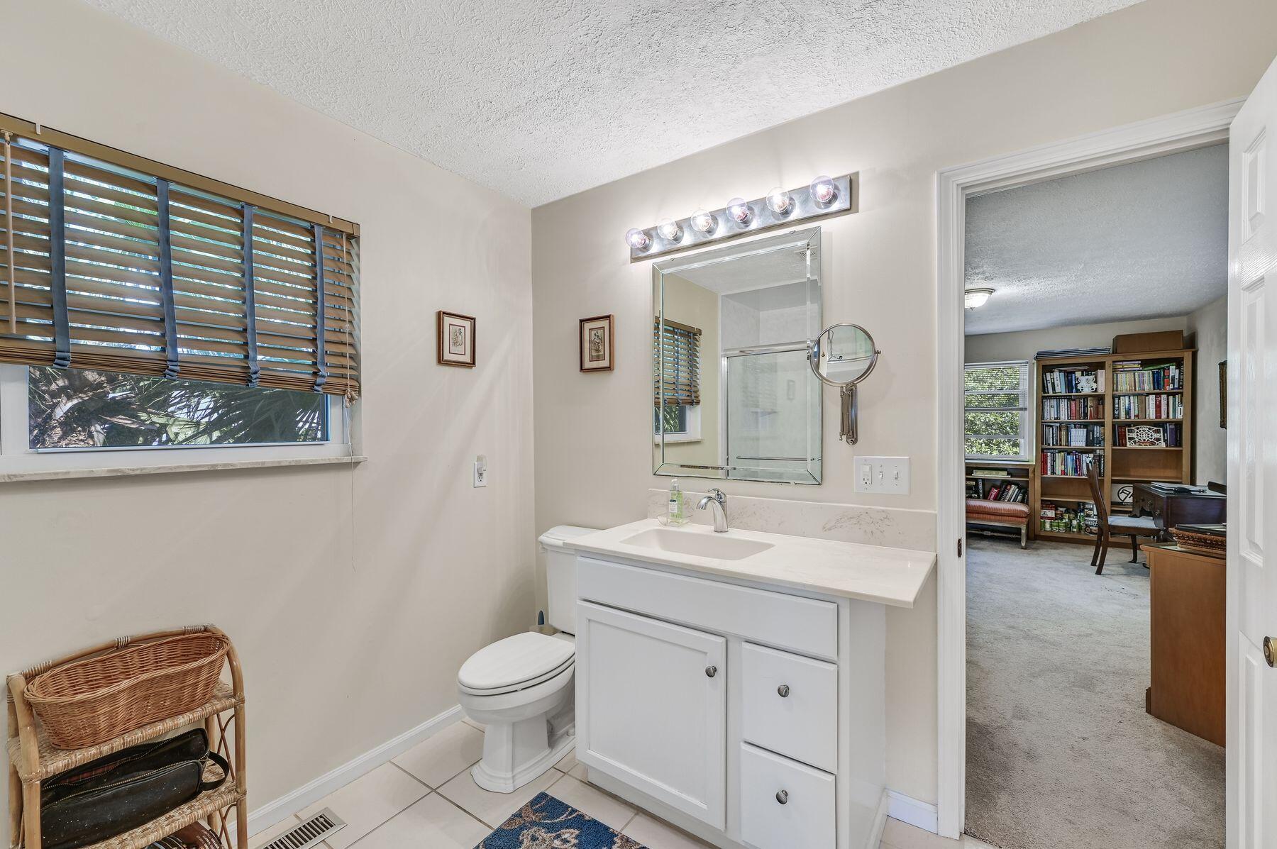 169 Pompano Street Inlet Beach, FL 32461 - Photo 26 of 49 a spacious bathroom with a toilet a sink and mirror