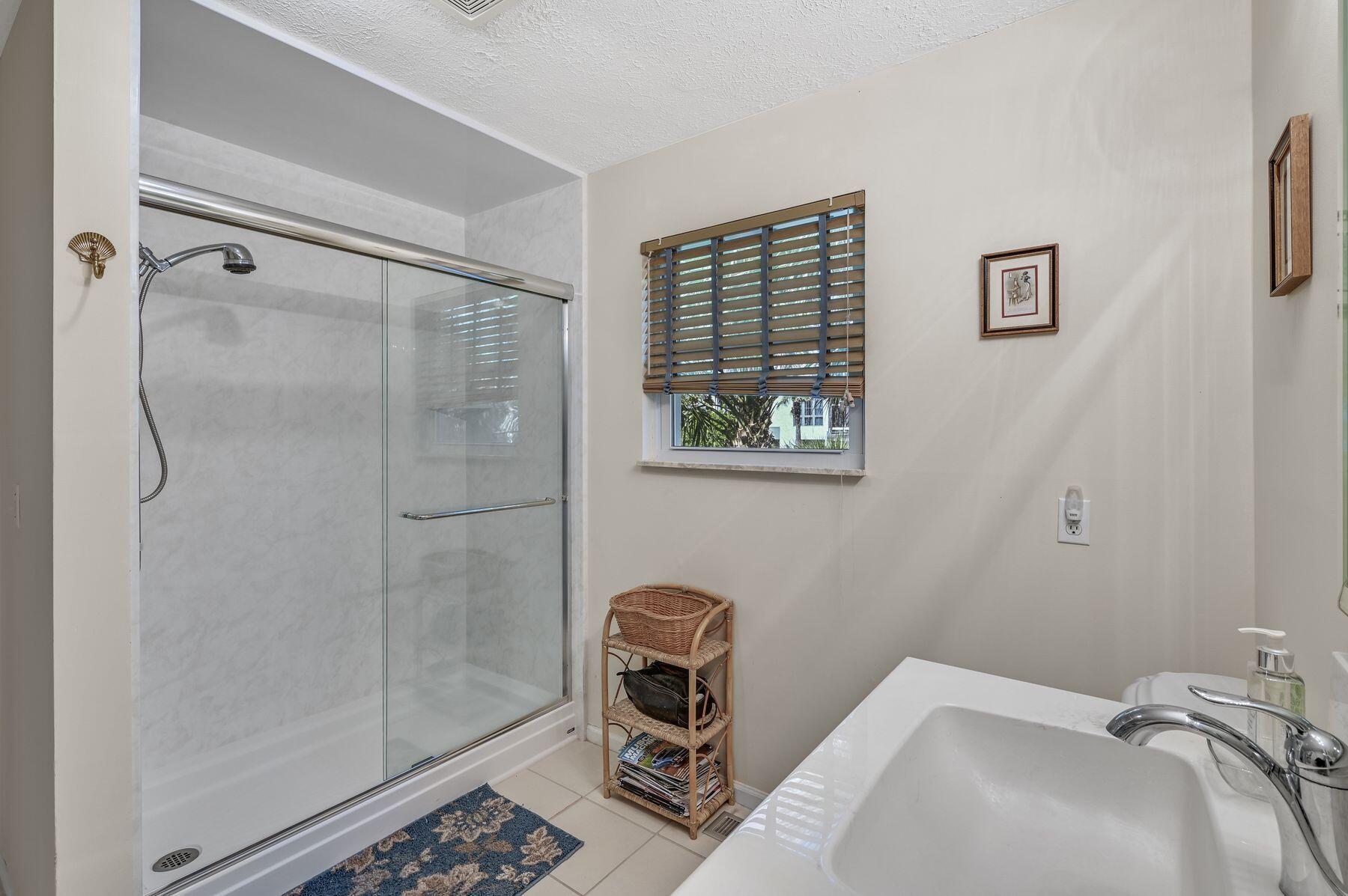 169 Pompano Street Inlet Beach, FL 32461 - Photo 27 of 49 a bathroom with a sink a mirror and a shower