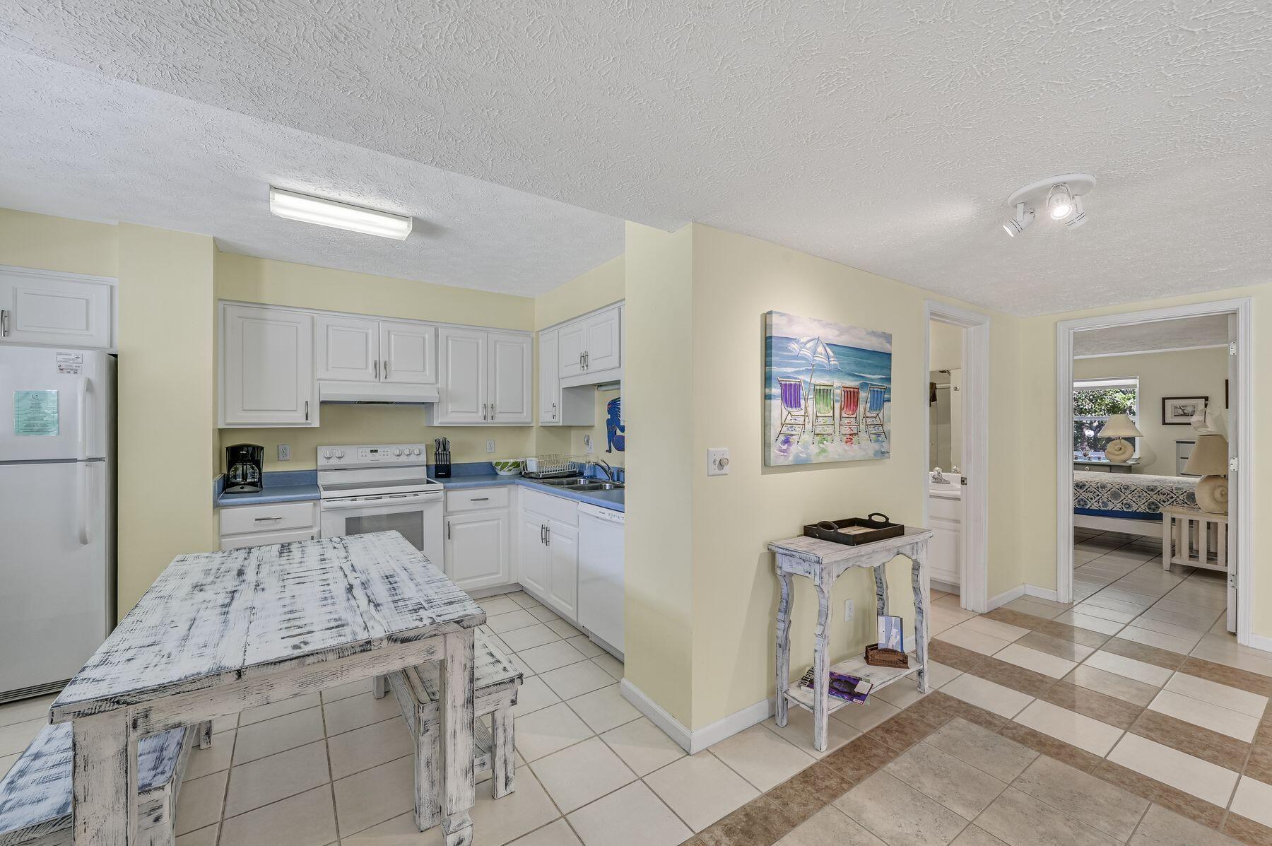 169 Pompano Street Inlet Beach, FL 32461 - Photo 41 of 49 a kitchen with stainless steel appliances kitchen island granite countertop a refrigerator and a stove top oven