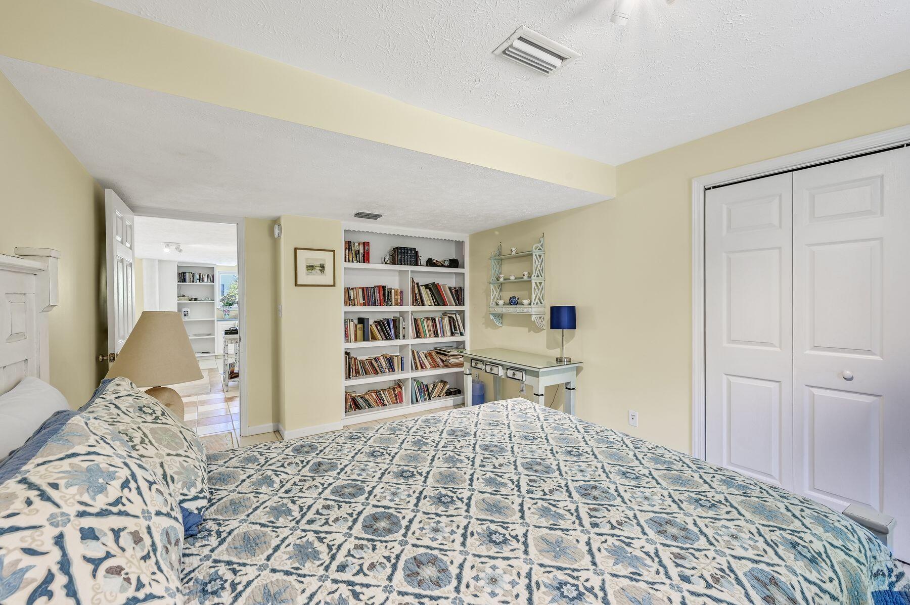 169 Pompano Street Inlet Beach, FL 32461 - Photo 44 of 49 a bedroom with a bed and closet with wooden floor