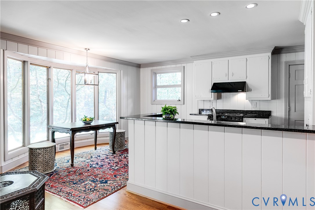 10475 Cherokee Road Richmond, VA 23235 - Photo 19 of 74 Kitchen featuring white cabinetry, black stone cou