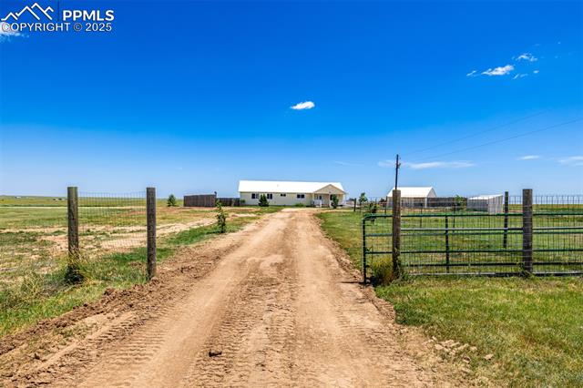 6065 Mulberry Road Calhan, CO 80808 - Photo 28 of 45 View of dirt / gravel road with a rural view and a gated entry