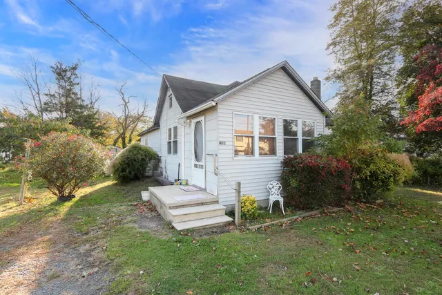 a view of a house with a yard and sitting area