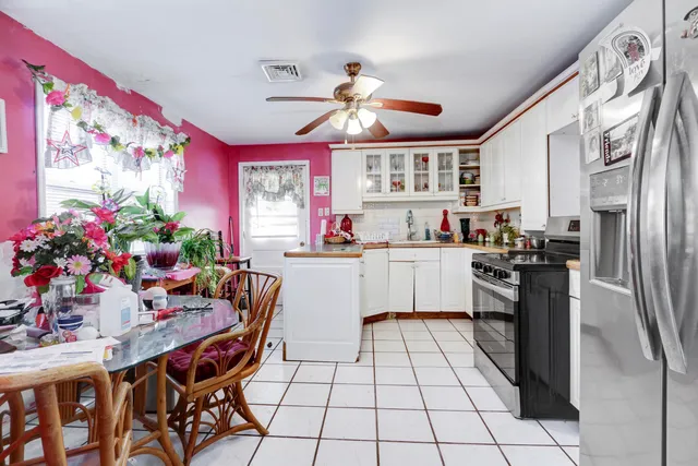 a kitchen with stainless steel appliances kitchen island granite countertop a sink and cabinets