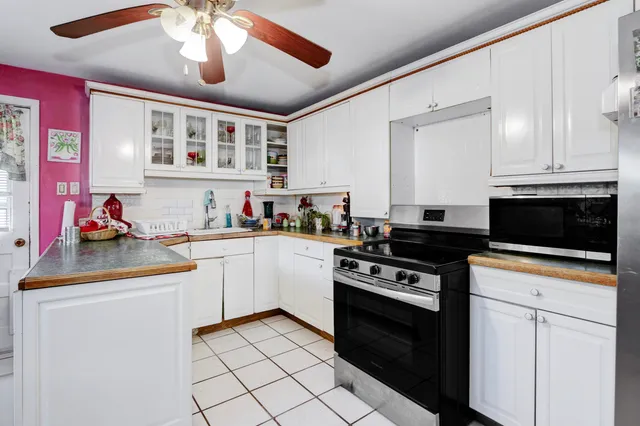 a kitchen with stainless steel appliances granite countertop a sink and cabinets