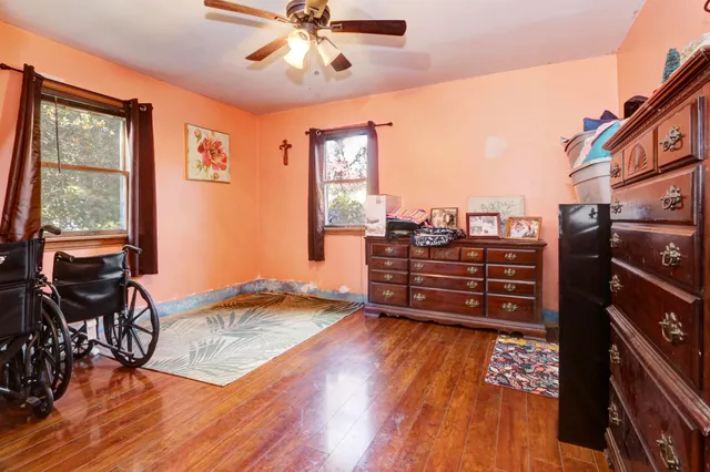 a living room with wooden floor and furniture