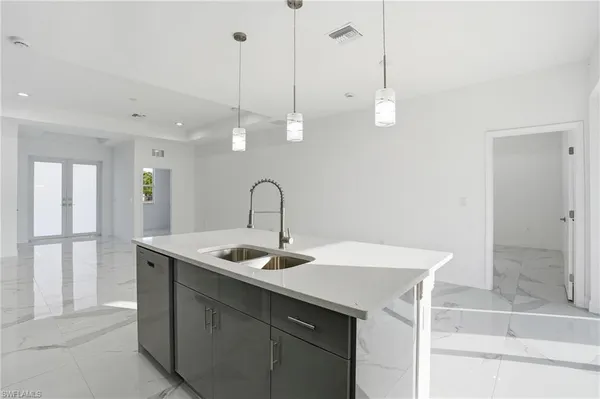 a kitchen with a sink a counter top space and cabinets