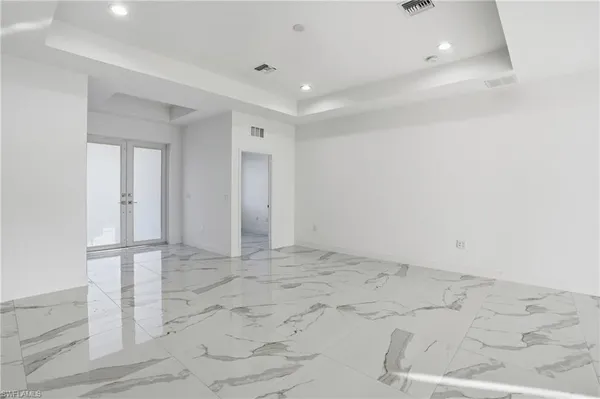 a view of a electric appliances in kitchen and an empty room
