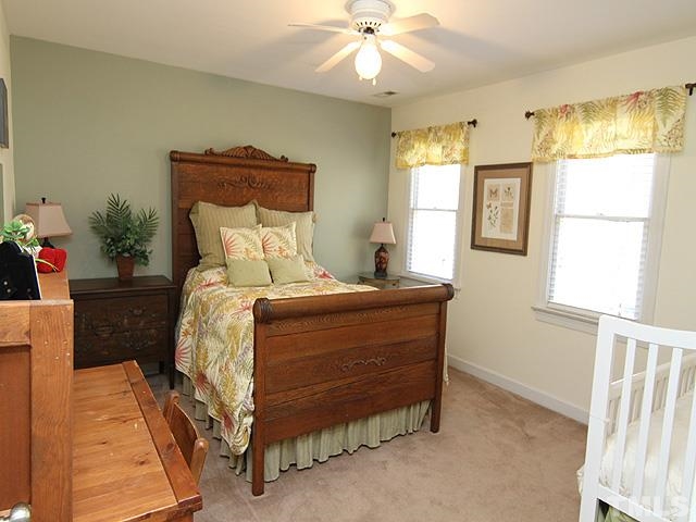 11800 Pembridge Lane Raleigh, NC 27613 - Photo 14 of 25 a bedroom with a bed and a chandelier