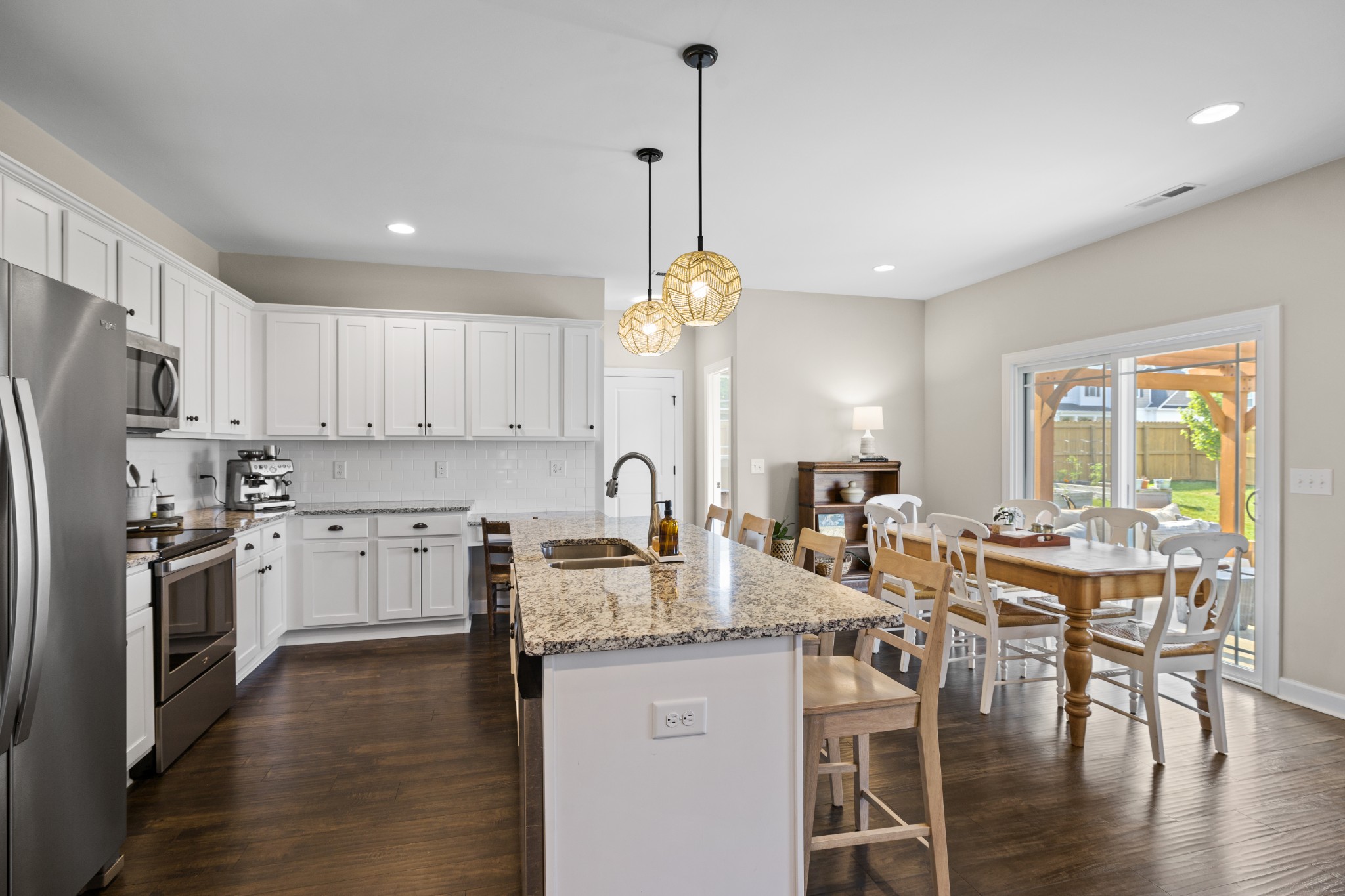 1006 Garrison Way Spring Hill, TN 37174 - Photo 15 of 46 a kitchen with center island white cabinets and stainless steel appliances
