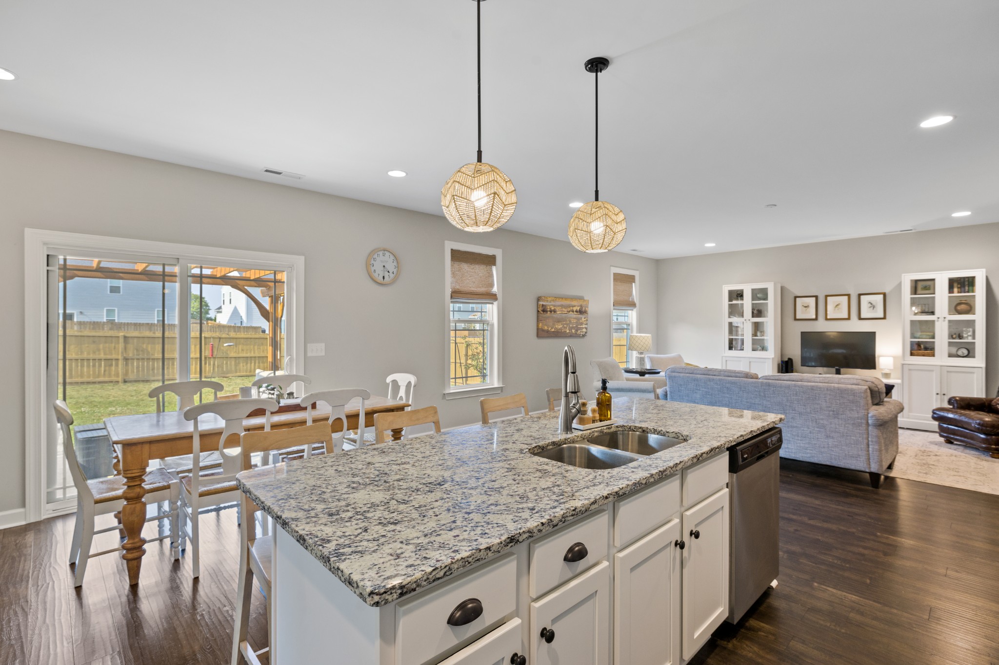 1006 Garrison Way Spring Hill, TN 37174 - Photo 17 of 46 a kitchen with granite countertop a stove a sink a dining table and chairs with wooden floor