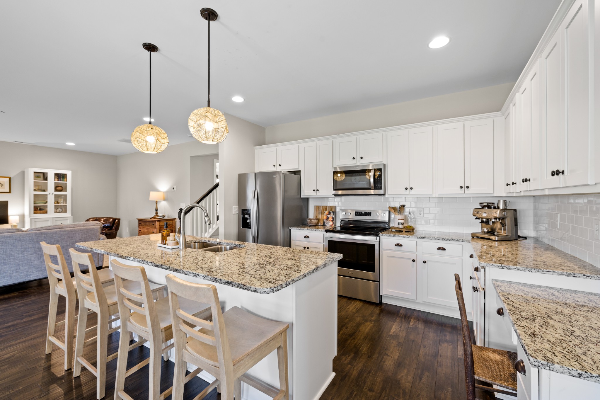 1006 Garrison Way Spring Hill, TN 37174 - Photo 20 of 46 a kitchen with stainless steel appliances granite countertop a stove top oven a refrigerator a sink a dining table and chairs with wooden floor