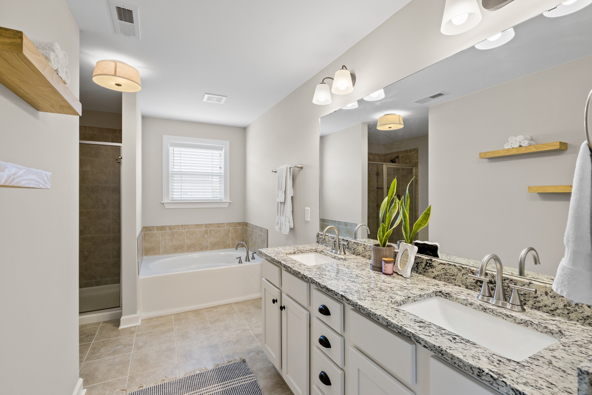 1006 Garrison Way Spring Hill, TN 37174 - Photo 28 of 46 a bathroom with a granite countertop sink mirror and a bathtub