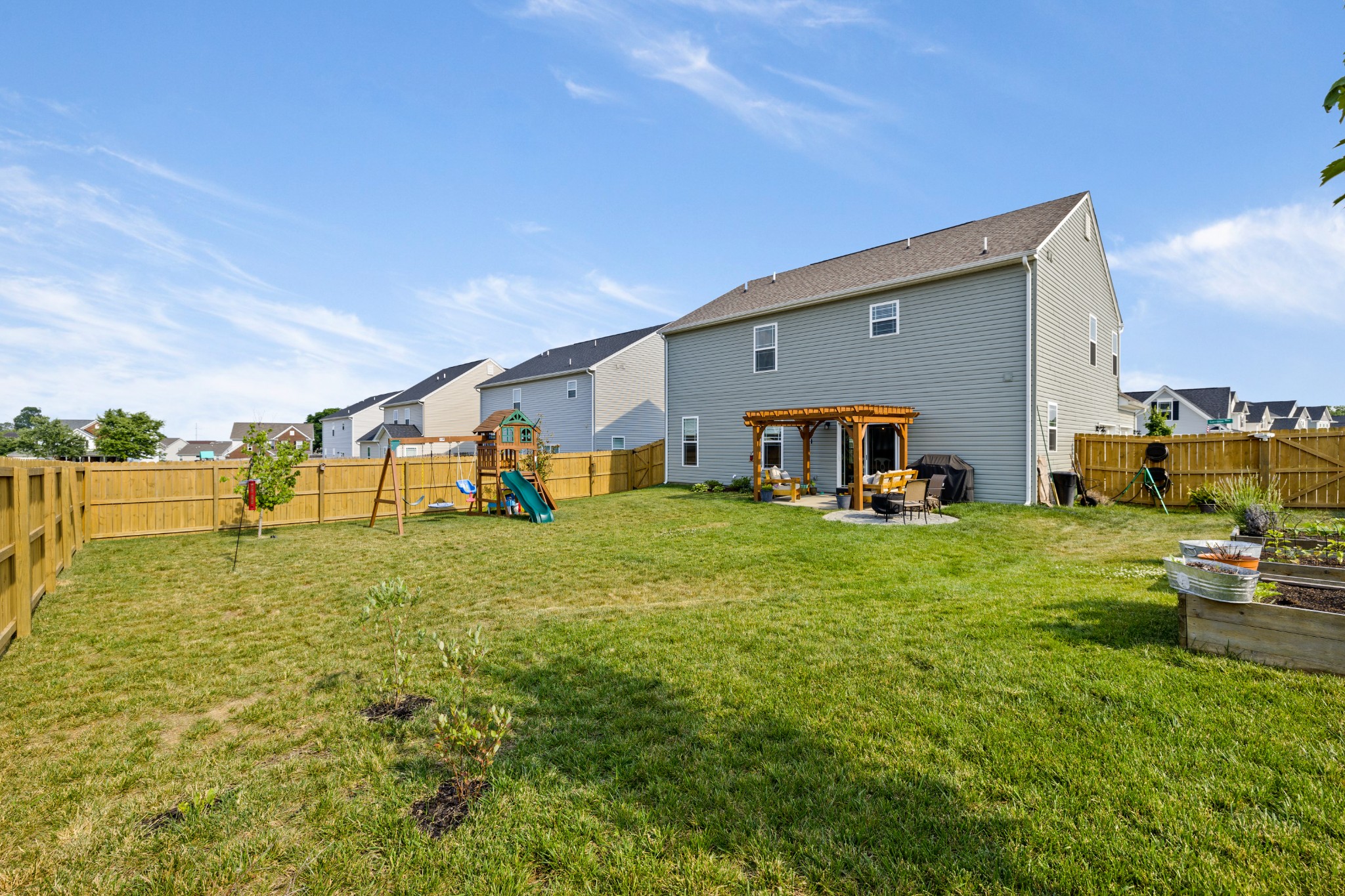 1006 Garrison Way Spring Hill, TN 37174 - Photo 46 of 46 a view of a house with backyard and a tree
