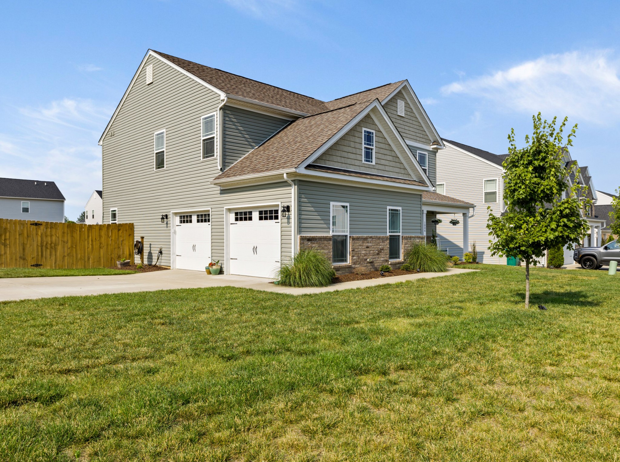 1006 Garrison Way Spring Hill, TN 37174 - Photo 5 of 46 a front view of a house with a yard and garage