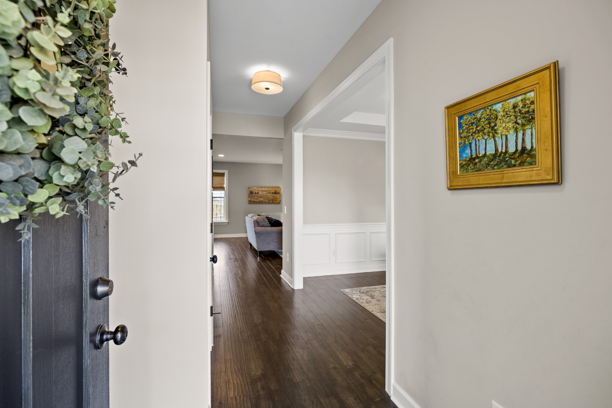 1006 Garrison Way Spring Hill, TN 37174 - Photo 6 of 46 a view of a hallway with wooden floor and a potted plant