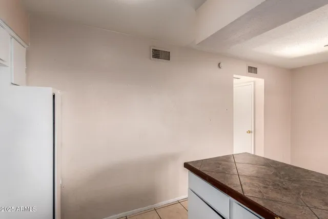 a room with a granite countertop sink and dishwasher