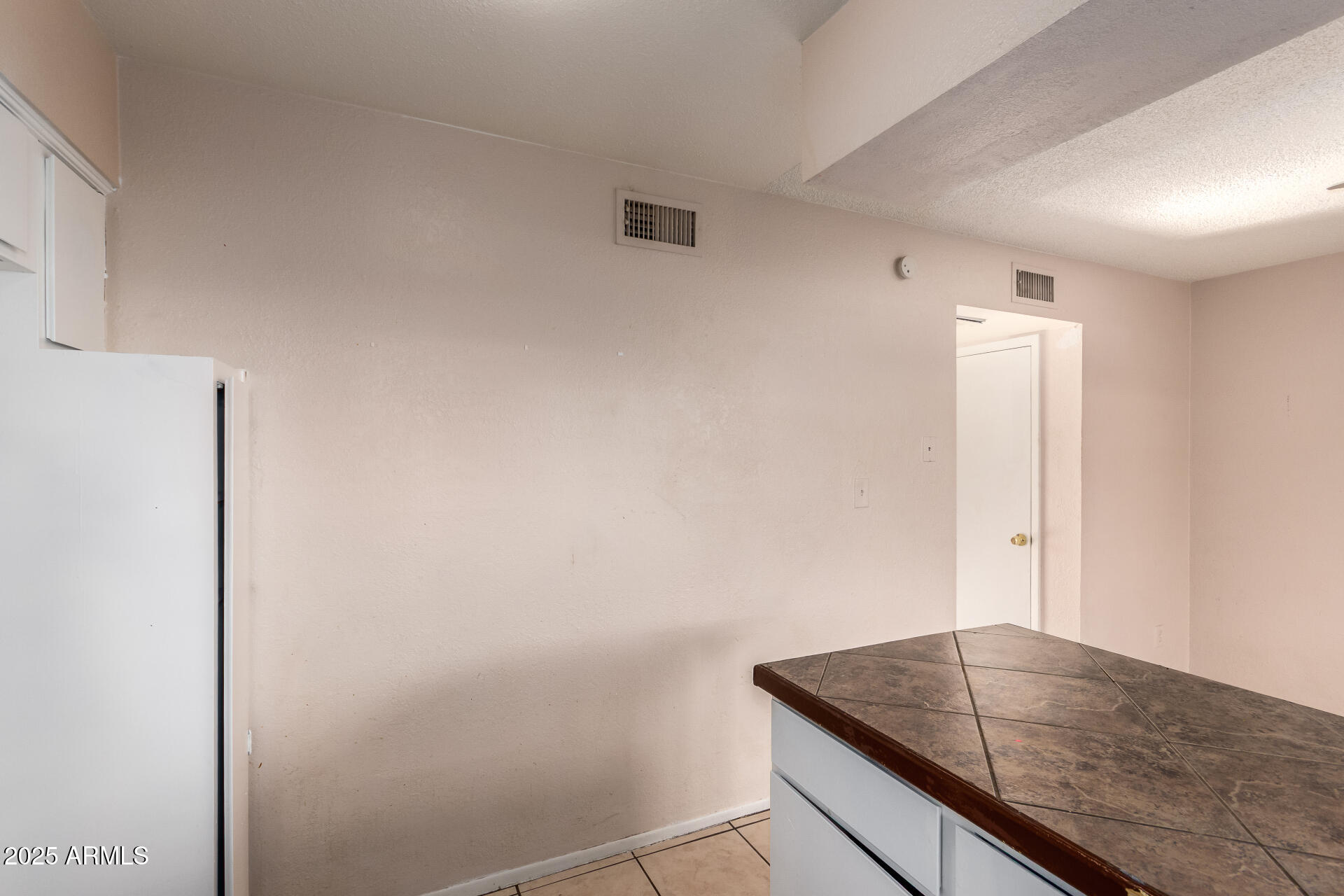 4625 West Thomas Road, Unit 43 Phoenix, AZ 85031 - Photo 11 of 26 a room with a granite countertop sink and dishwasher