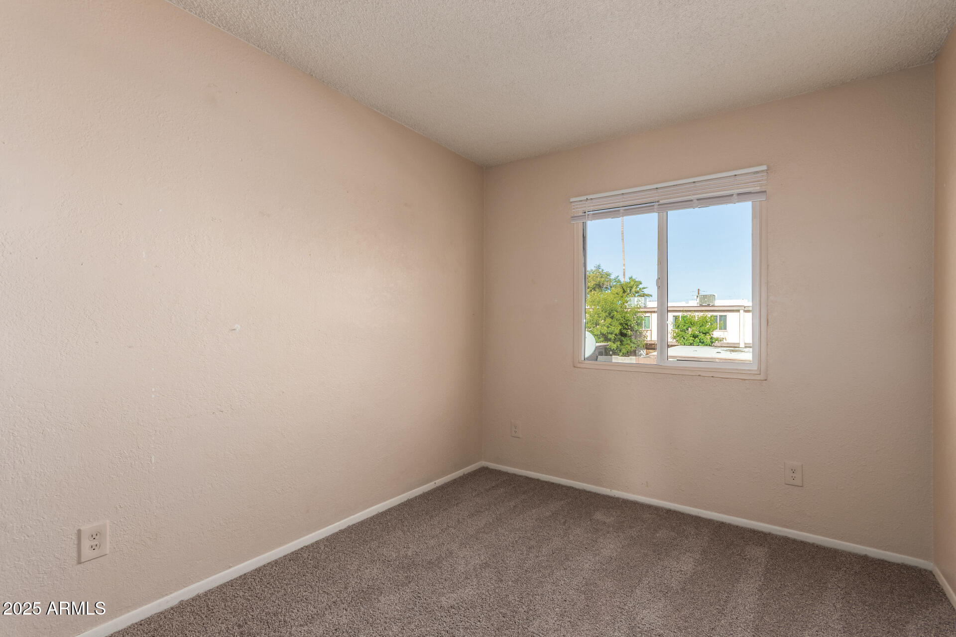 4625 West Thomas Road, Unit 43 Phoenix, AZ 85031 - Photo 12 of 26 an empty room with a window