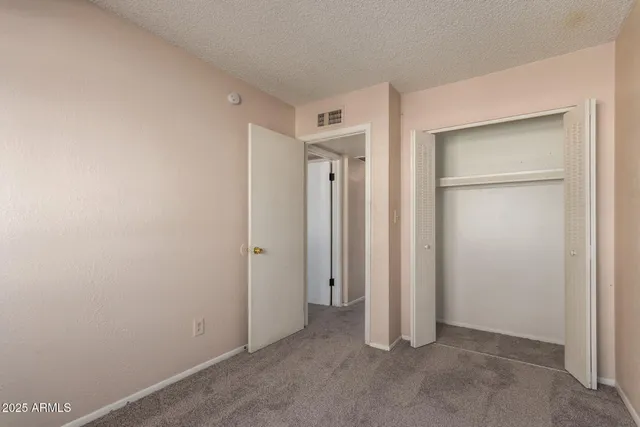 an empty room with closet area