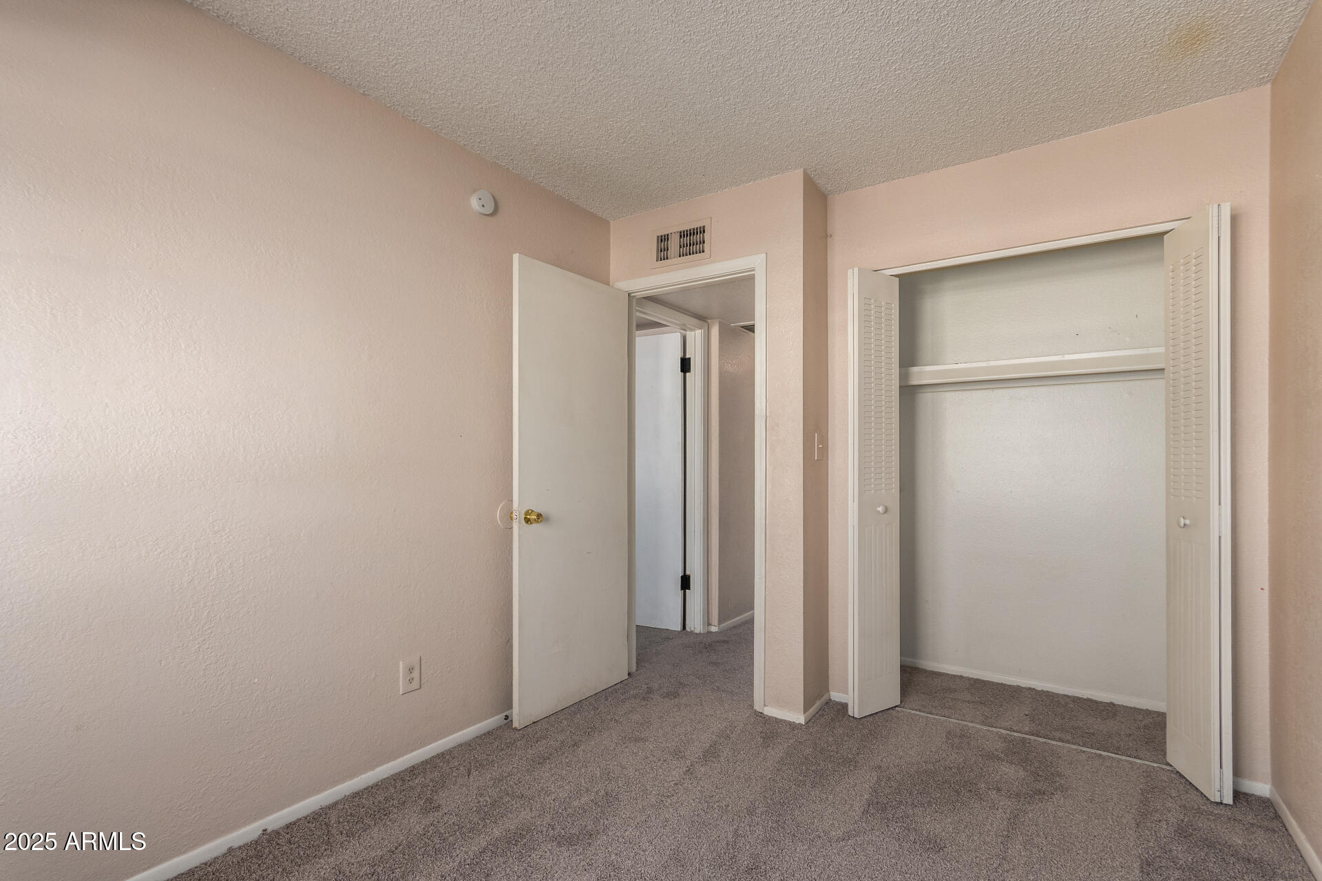 4625 West Thomas Road, Unit 43 Phoenix, AZ 85031 - Photo 13 of 26 an empty room with closet area
