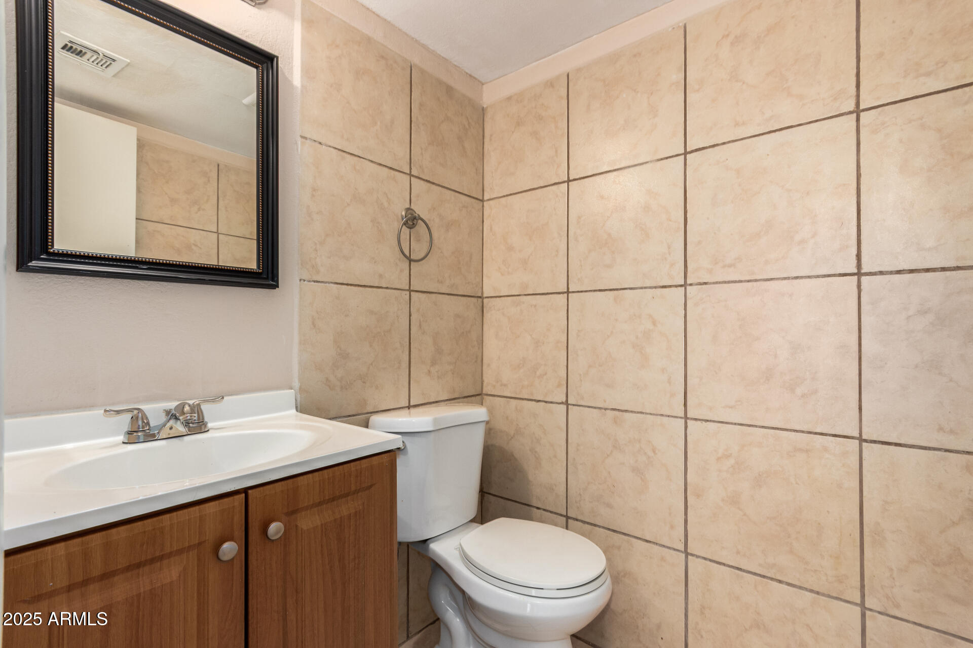 4625 West Thomas Road, Unit 43 Phoenix, AZ 85031 - Photo 15 of 26 a bathroom with a sink a toilet and mirror
